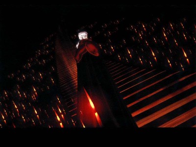Hundreds of candles burning in darkness
